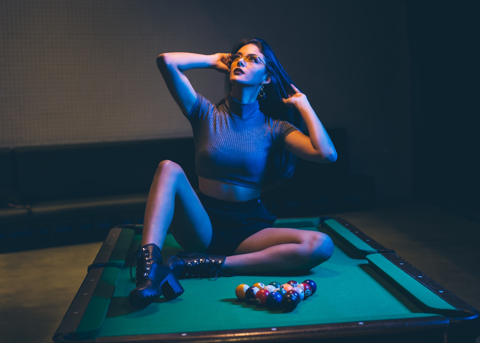 Woman Sitting on Pool Table