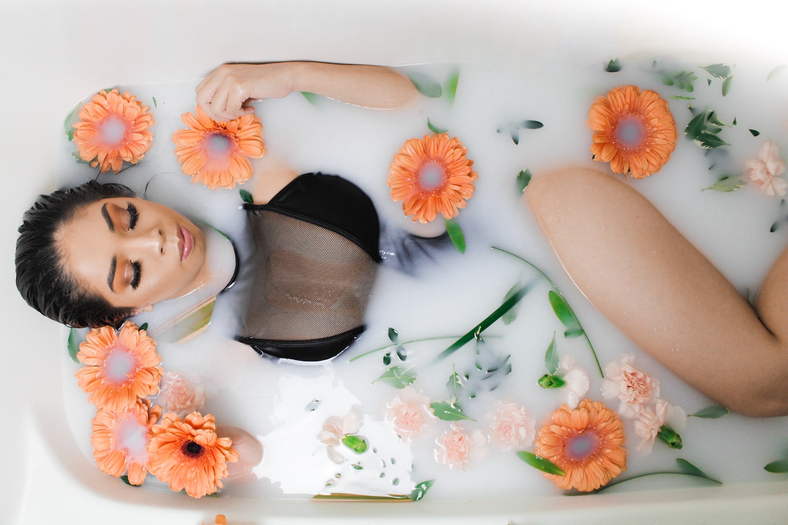 Woman Lying on a Bathtub with Flowers