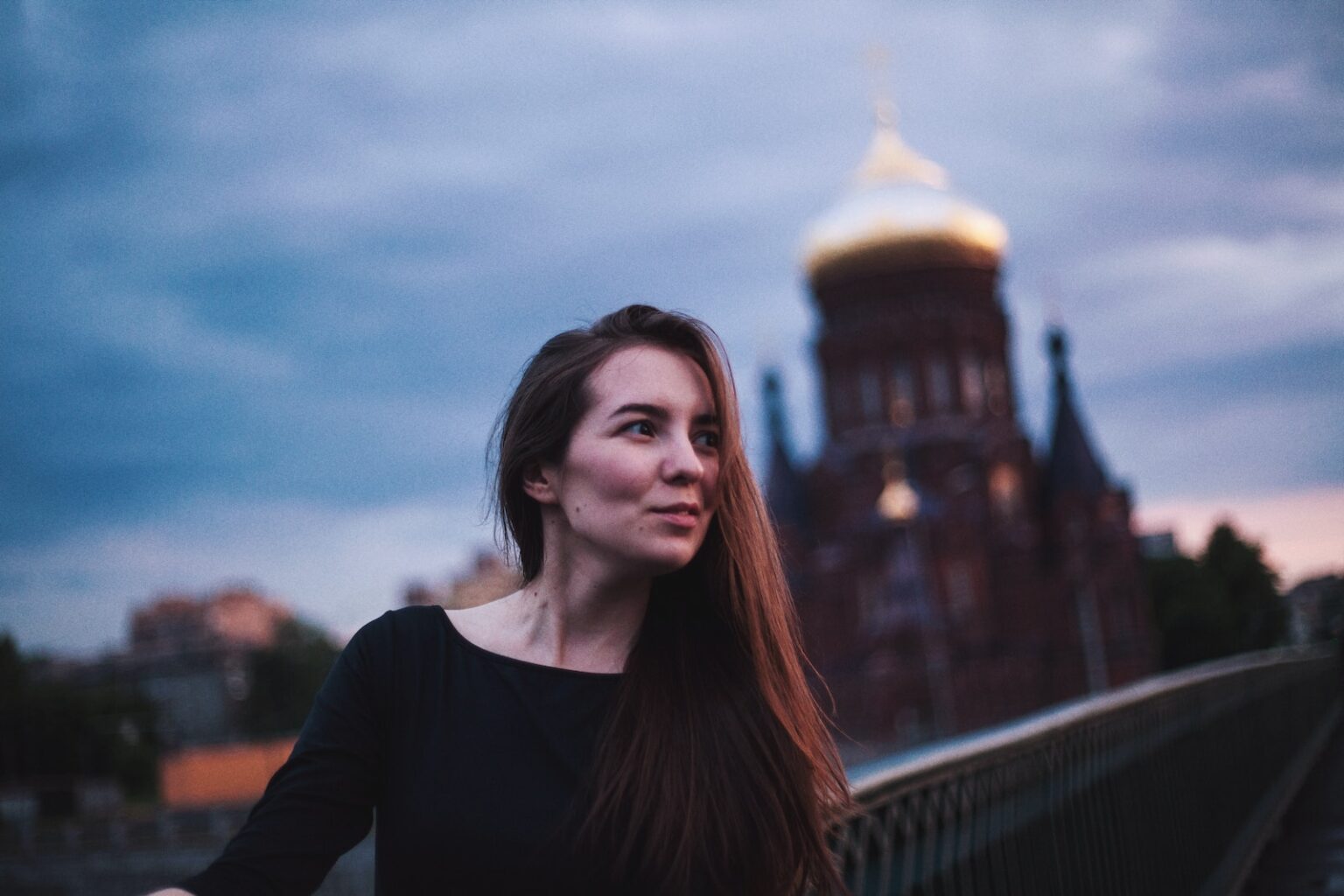 woman taking photo near building
