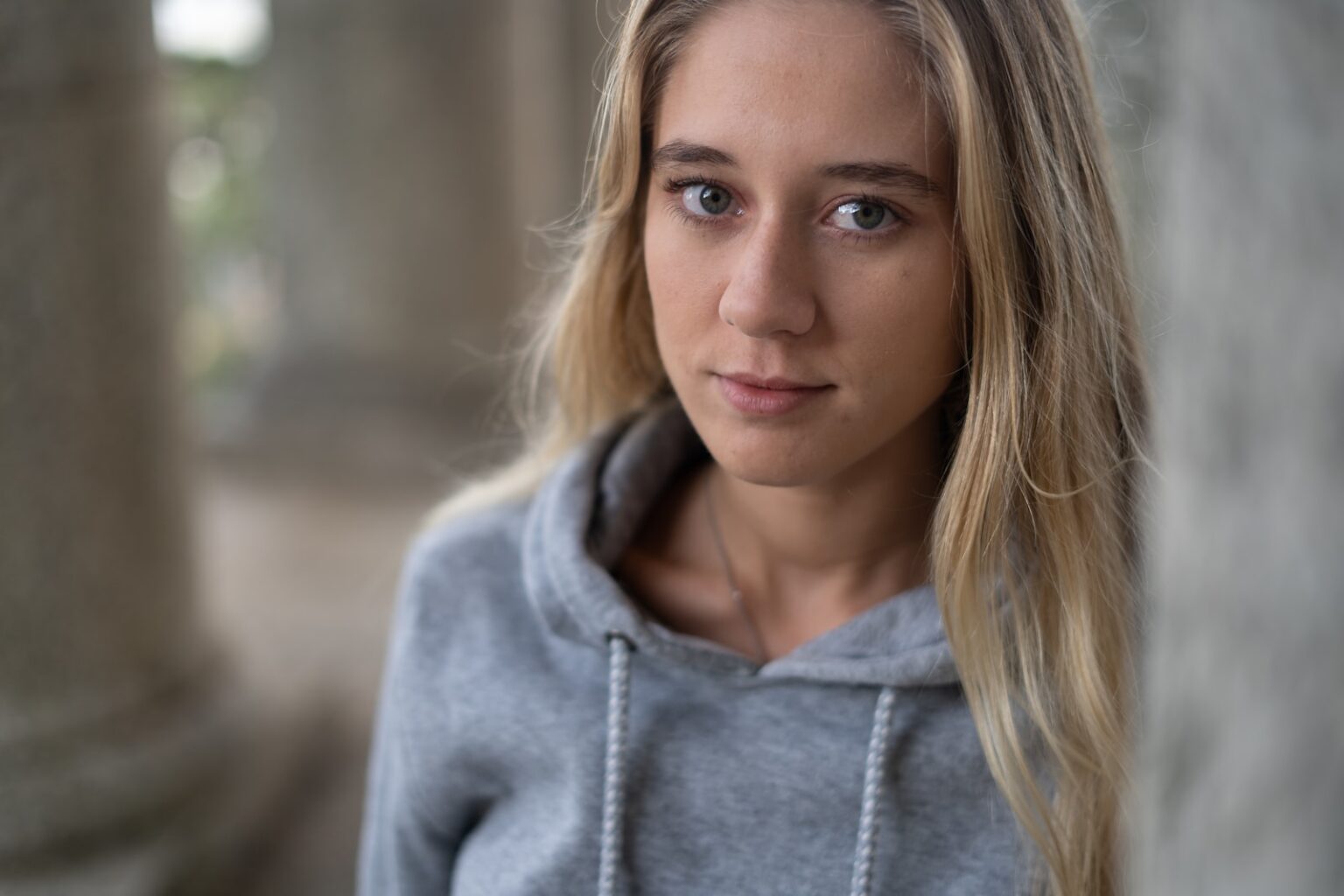 woman in gray hoodie smiling